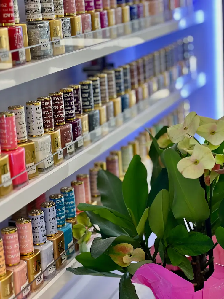 Close-up of nail polish bottles and plant