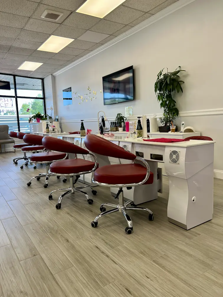 Manicure station with red chairs and polish display